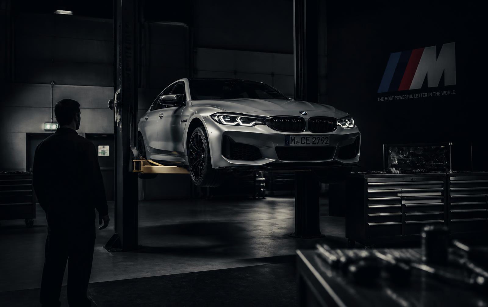 Premium sedan on a lift inside a modern service workshop